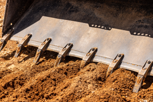 Bobcat bucket scooping dirt in lethbridge alberta