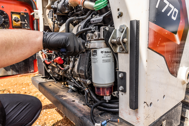 Bobcat fuel filter installed on skid steer chinook equipment lethbridge